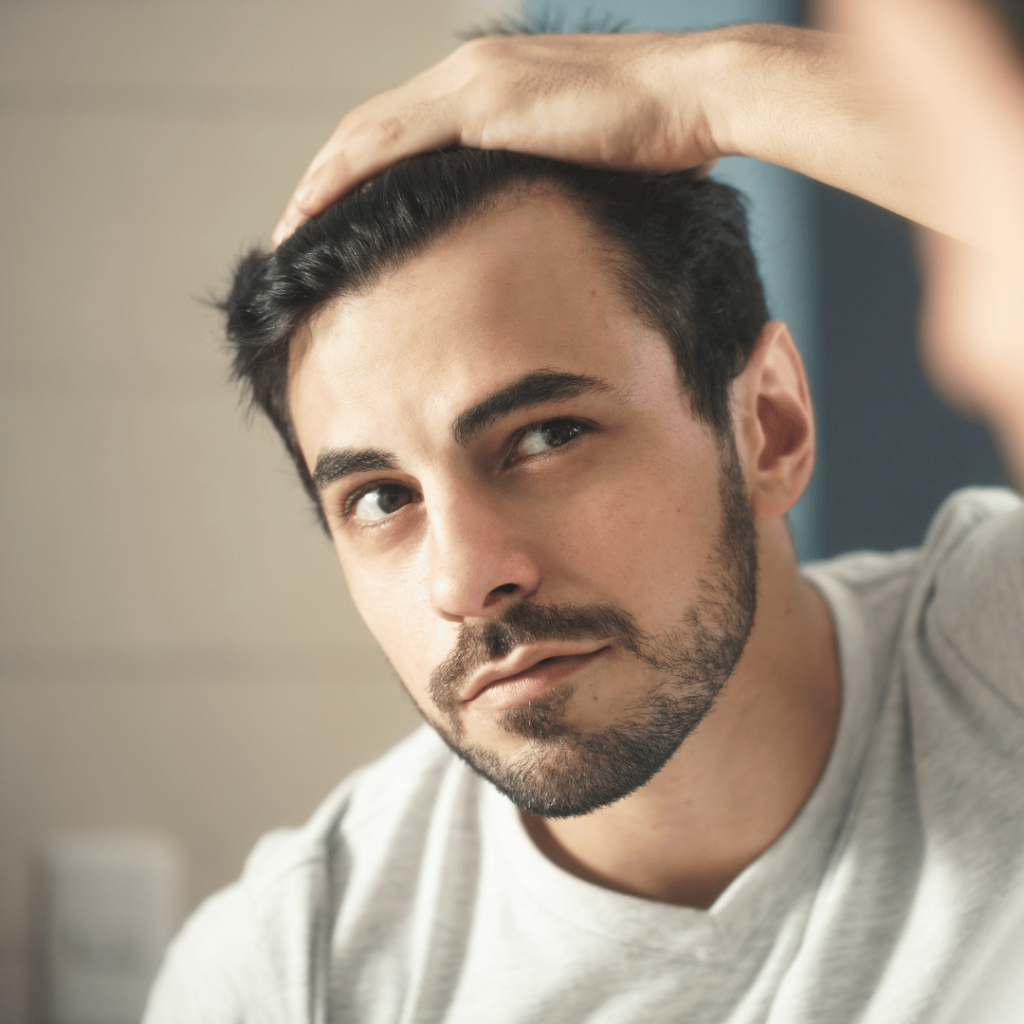 Man Worried for Alopecia Checking Hair for Loss